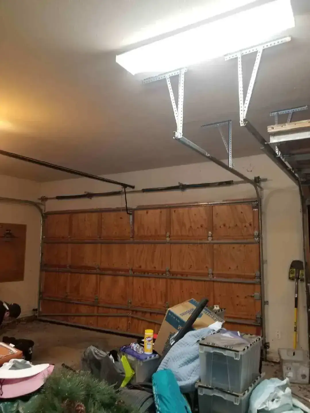 A garage filled with lots of boxes and a christmas tree.
