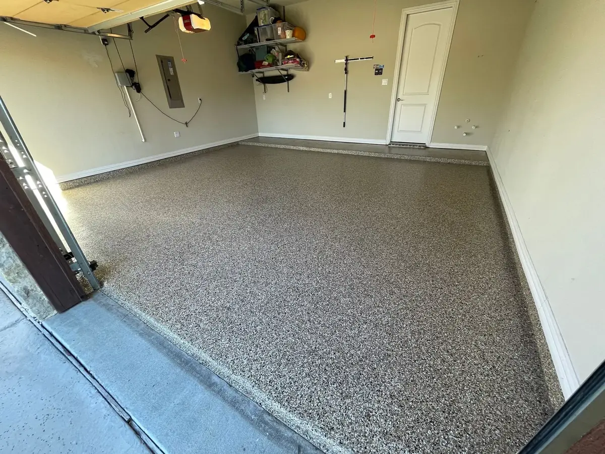 A garage with a concrete floor and a garage door.