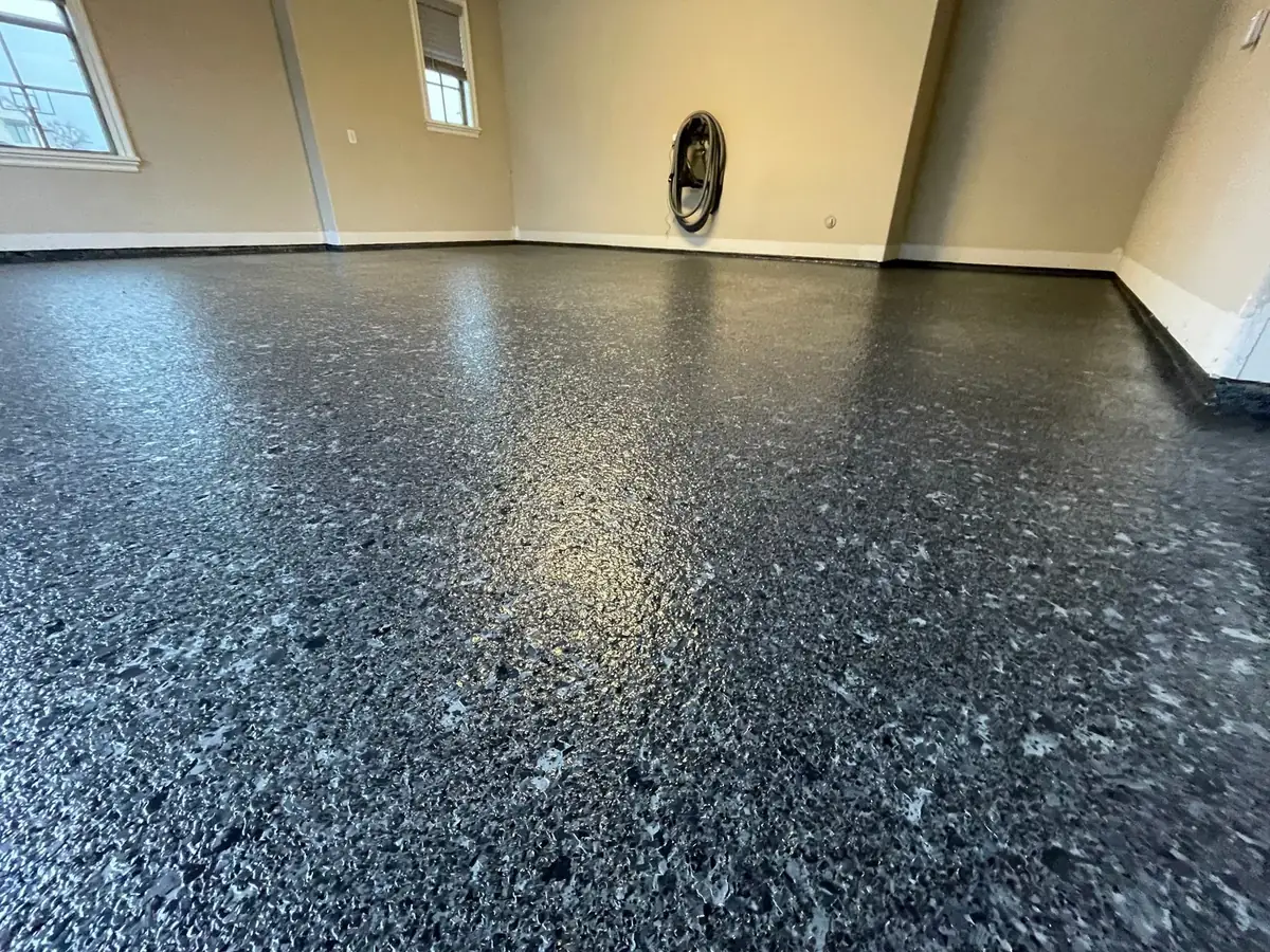 A close up of a black concrete floor in a garage.